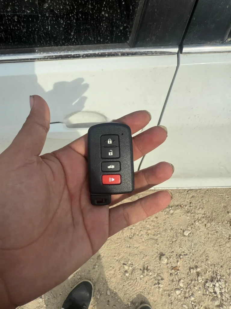 vehicle key fob checked beside a car, real company service photo 1